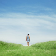 Girl walking on grass field